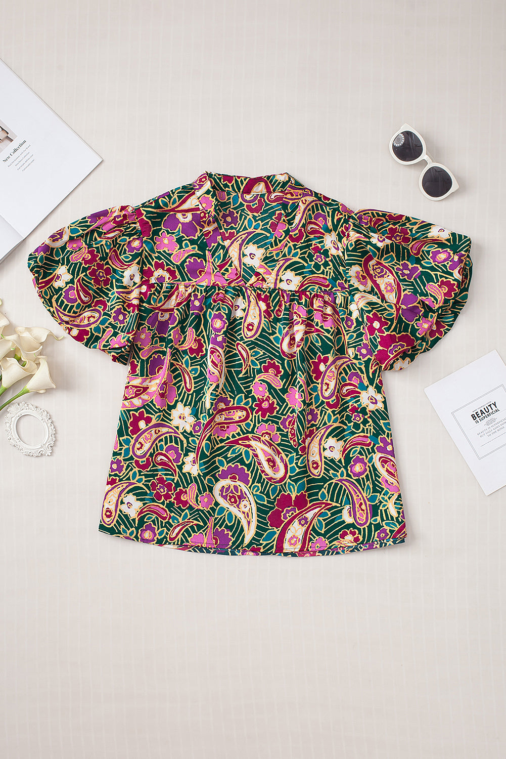 A stylish V Neck Short Bubble Sleeve Paisley Blouse featuring a vibrant paisley print, short bubble sleeves, and a loose fit, perfect for casual or formal wear.