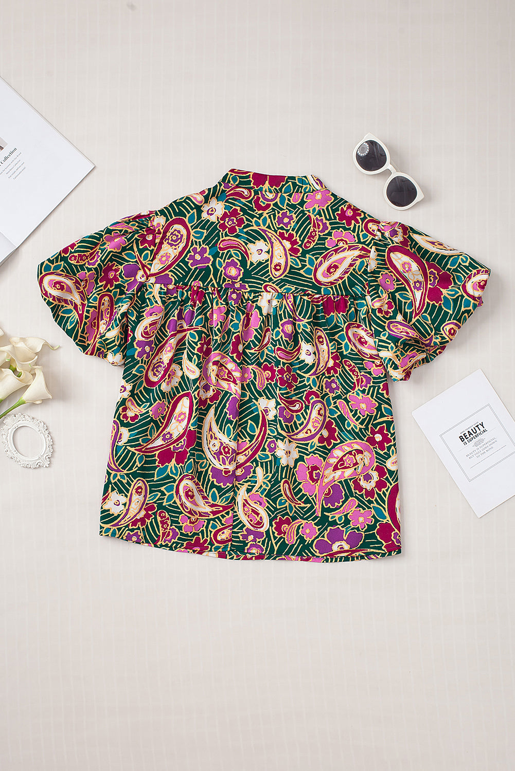 A stylish V Neck Short Bubble Sleeve Paisley Blouse featuring a vibrant paisley print, short bubble sleeves, and a loose fit, perfect for casual or formal wear.