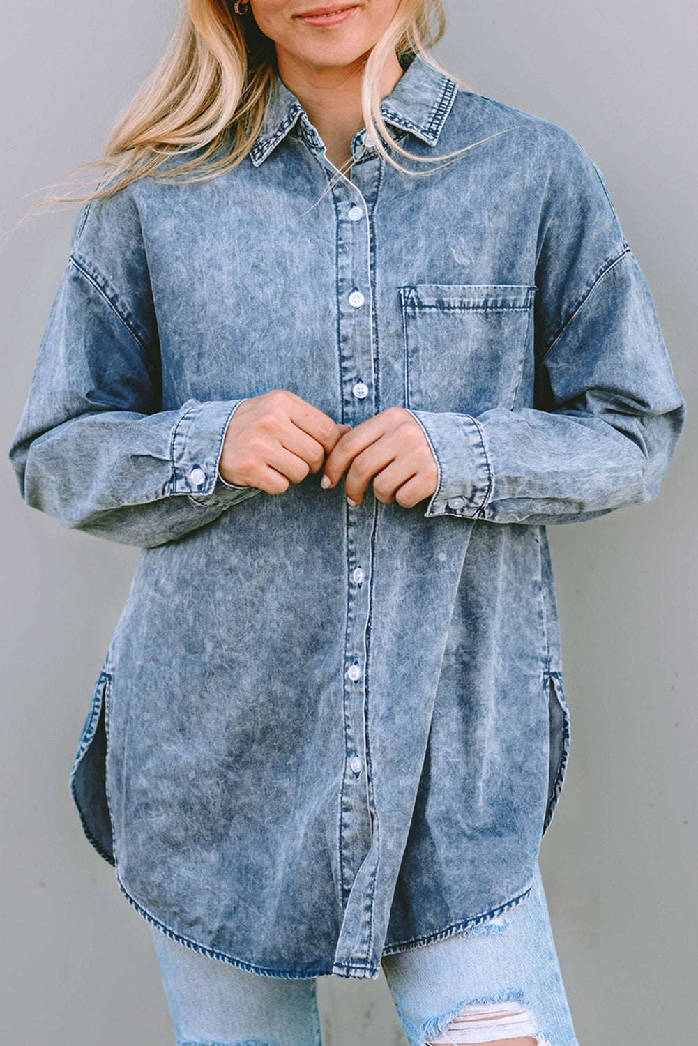 A stylish Vintage Washed Chest Pocket Denim Shirt in light blue, featuring a fitted silhouette and elegant button details.