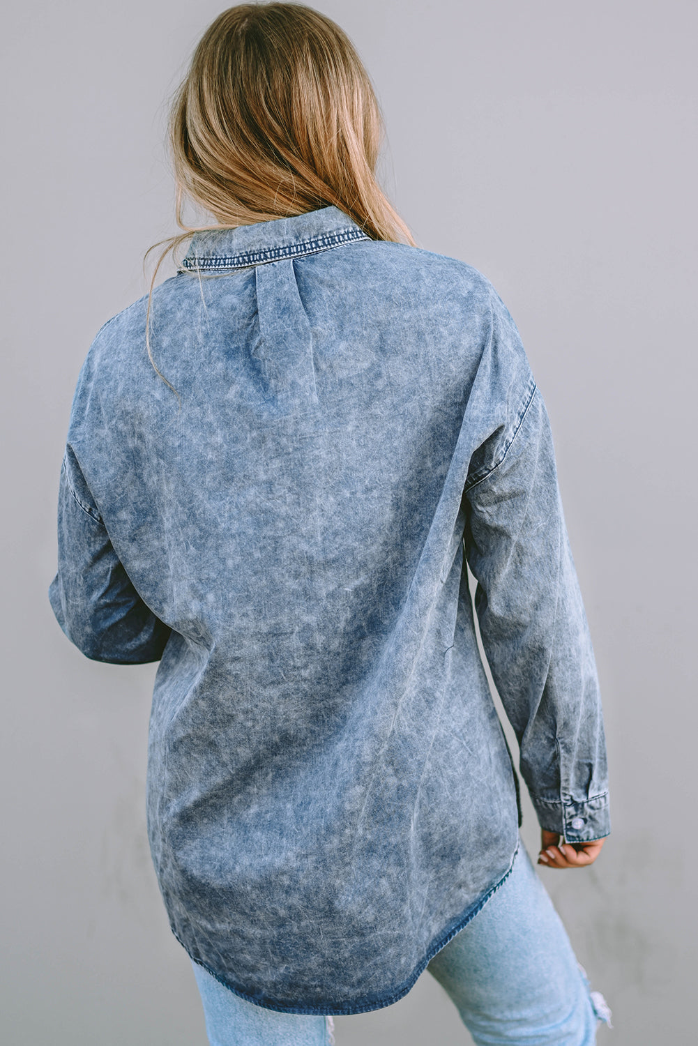 A stylish Vintage Washed Chest Pocket Denim Shirt in light blue, featuring a fitted silhouette and elegant button details.