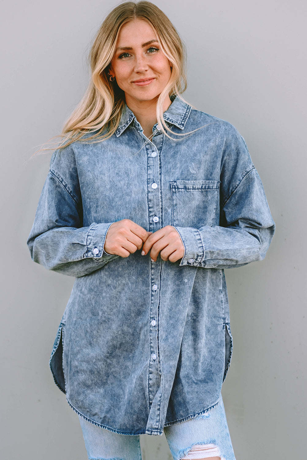 A stylish Vintage Washed Chest Pocket Denim Shirt in light blue, featuring a fitted silhouette and elegant button details.