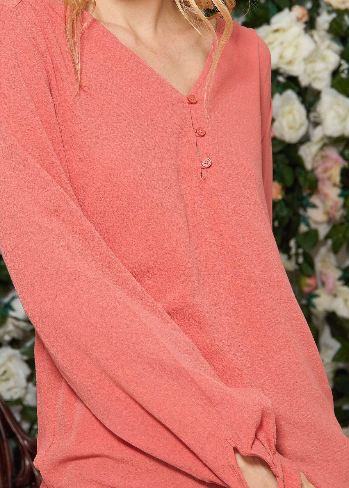 V-neck Tie Cuff Blouse in Faded Coral with floral print and tie cuff sleeves, showcasing a stylish hi-lo hem.