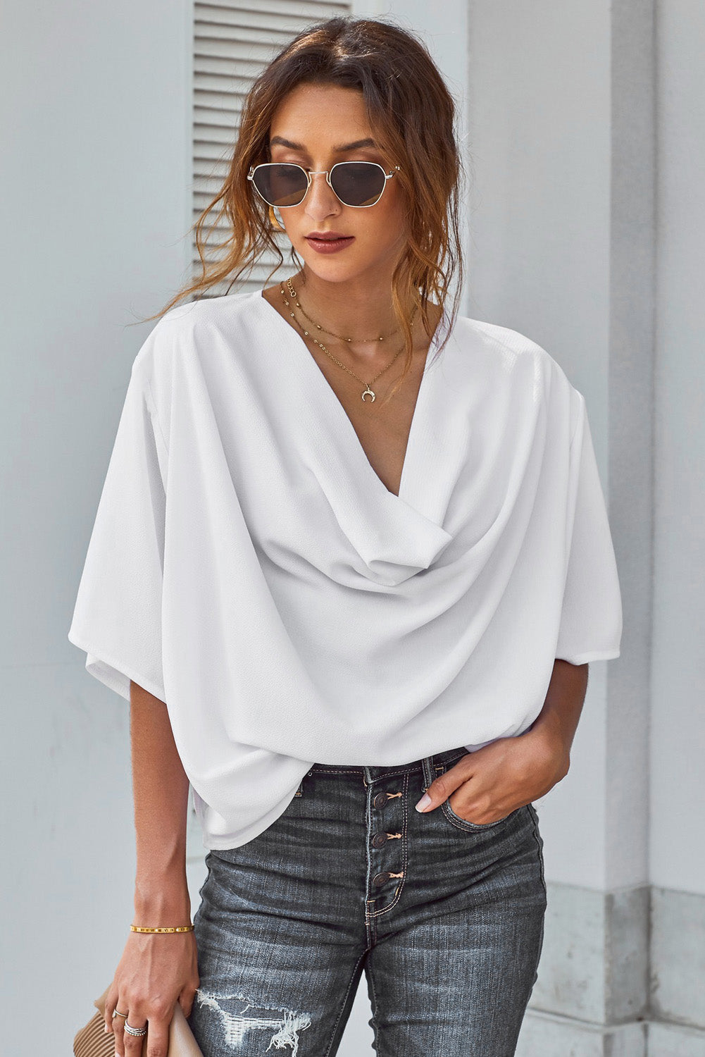 White draped short sleeve chic blouse with a loose front design, perfect for casual and semi-formal occasions.