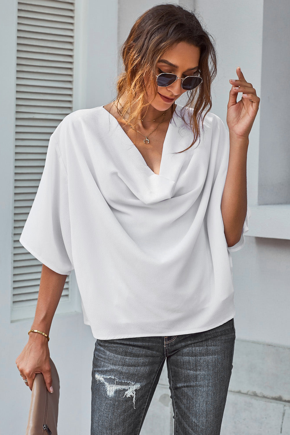 White draped short sleeve chic blouse with a loose front design, perfect for casual and semi-formal occasions.