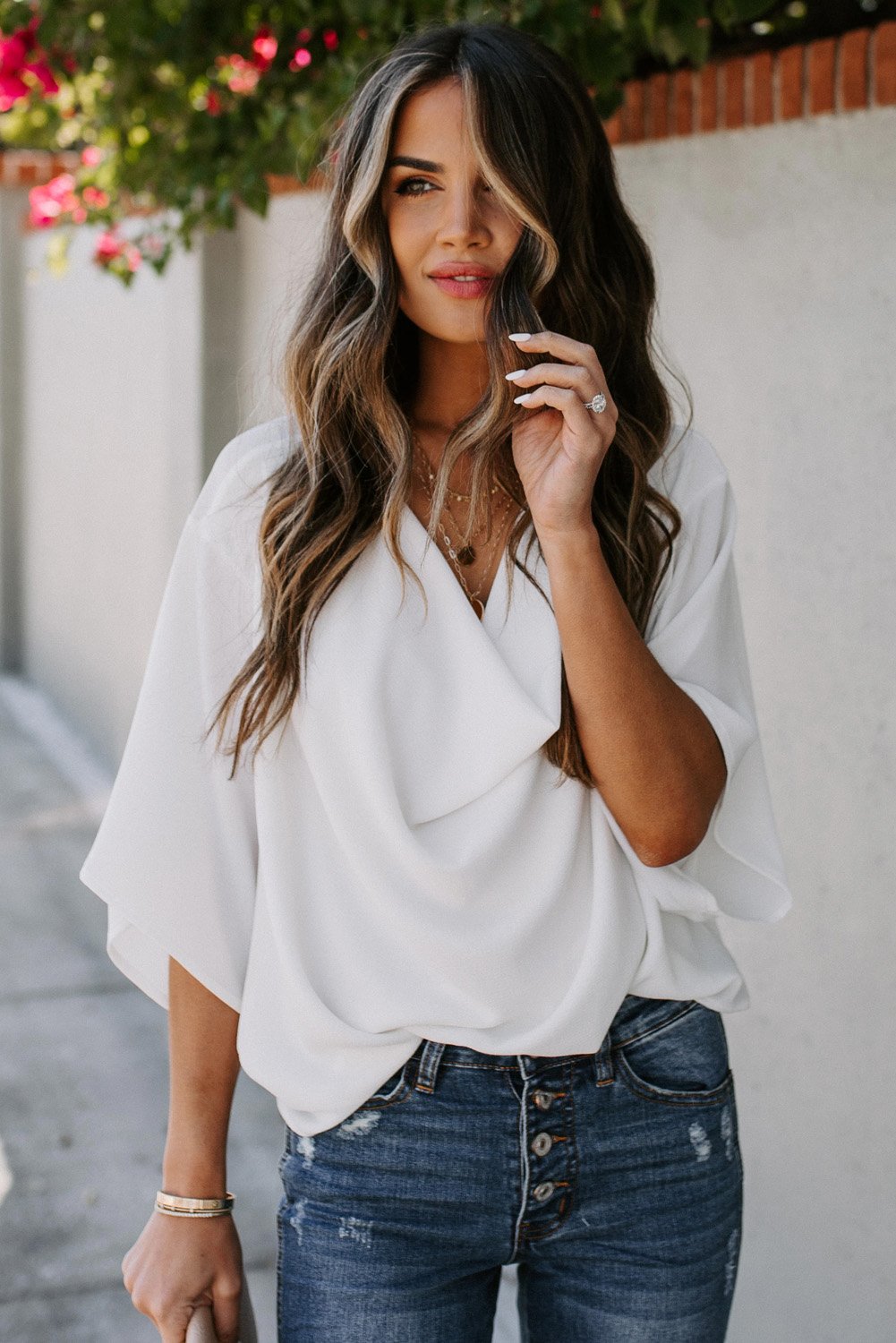 White draped short sleeve chic blouse with a loose front design, perfect for casual and semi-formal occasions.