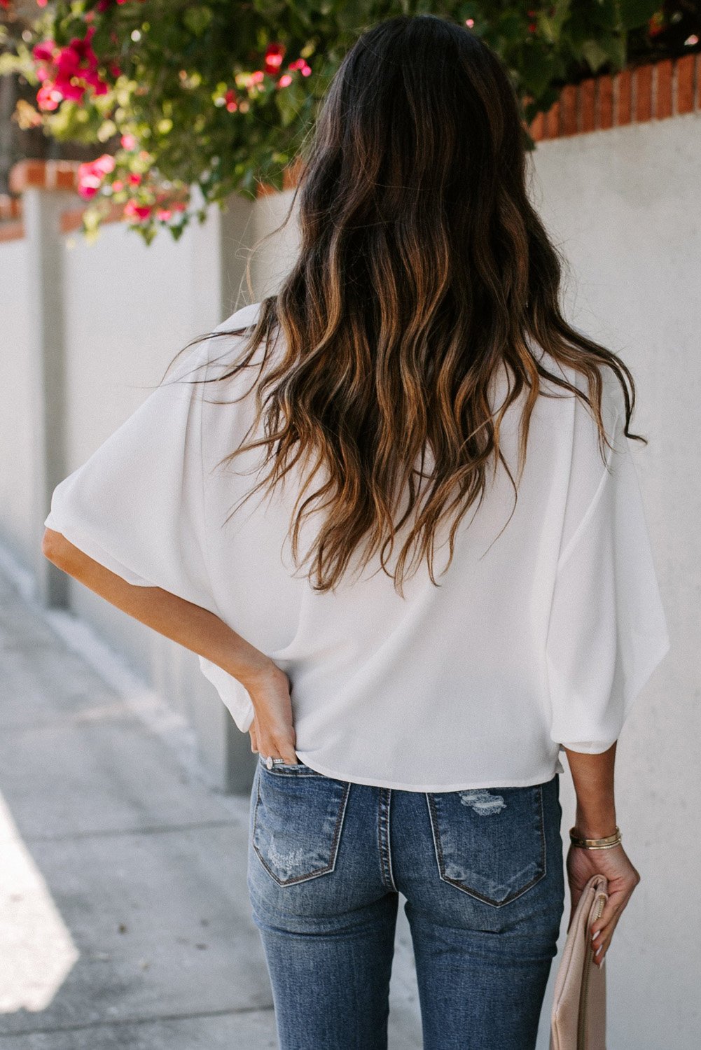 White draped short sleeve chic blouse with a loose front design, perfect for casual and semi-formal occasions.