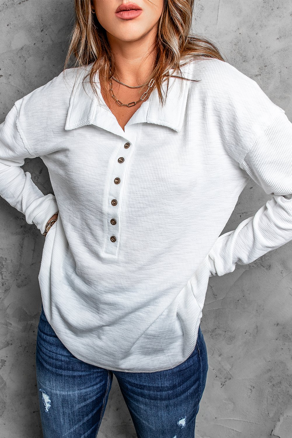 A stylish white long sleeve top with a turn-down neck and button closure, perfect for casual wear in spring and autumn.