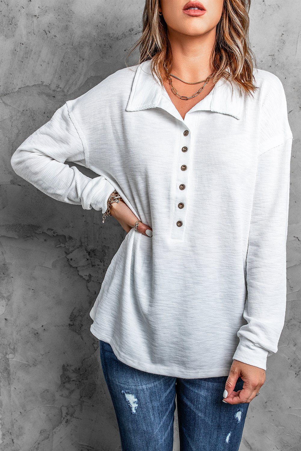 A stylish white long sleeve top with a turn-down neck and button closure, perfect for casual wear in spring and autumn.