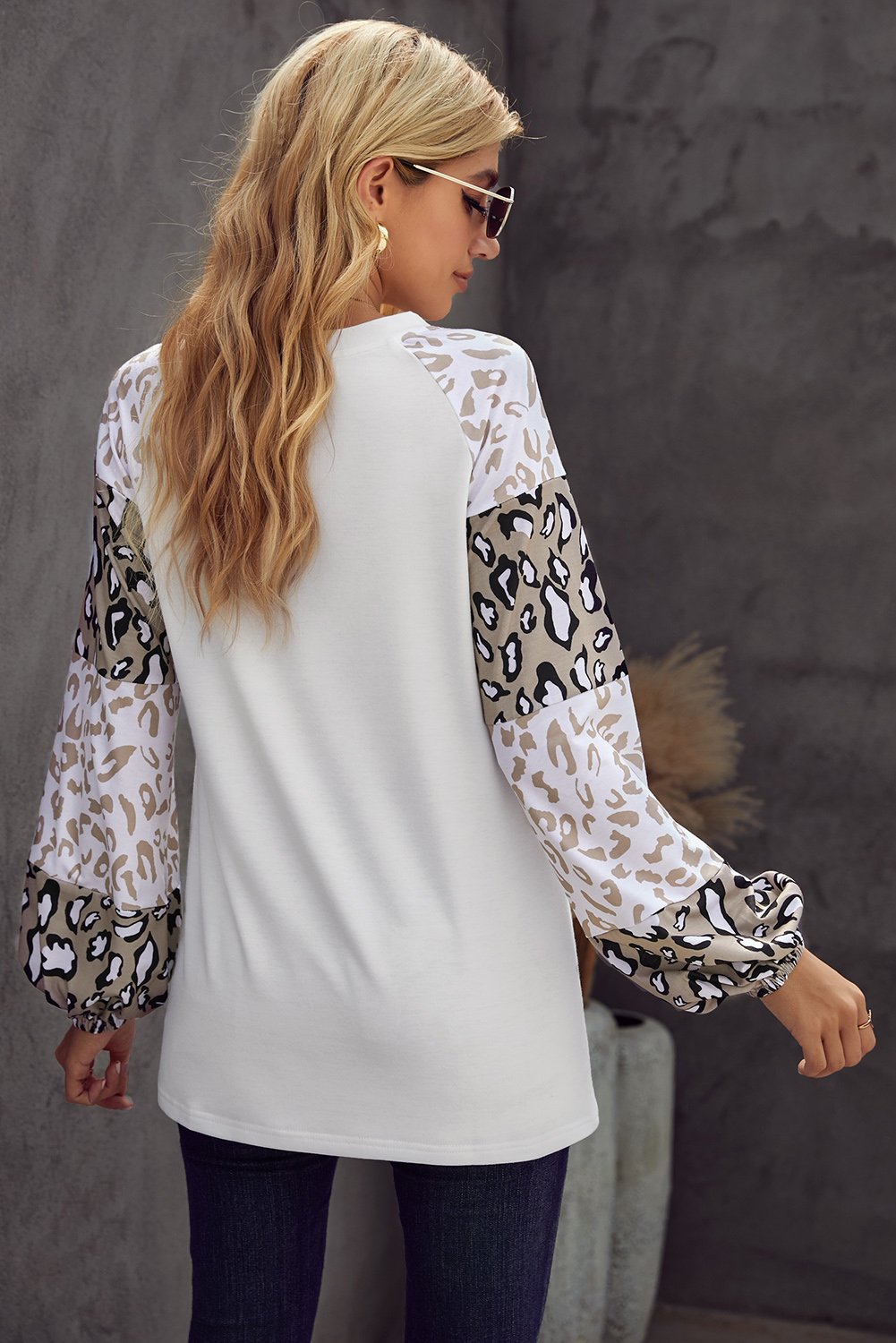 Women wearing a beige leopard print bubble sleeve top, showcasing its trendy design and comfortable fit.