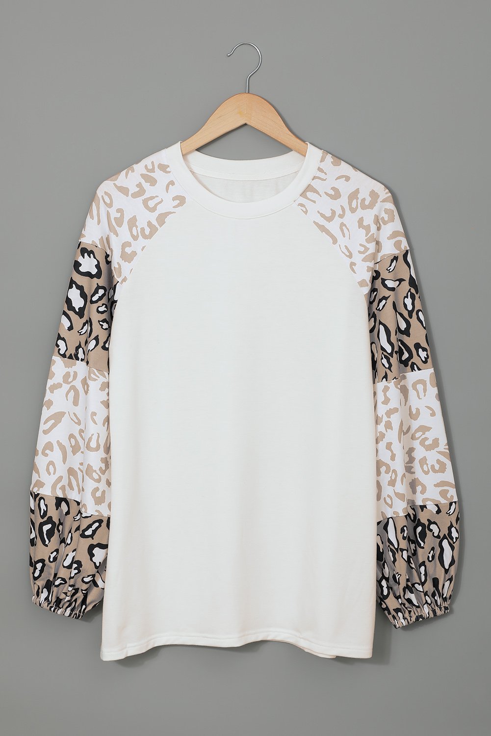 Women wearing a beige leopard print bubble sleeve top, showcasing its trendy design and comfortable fit.