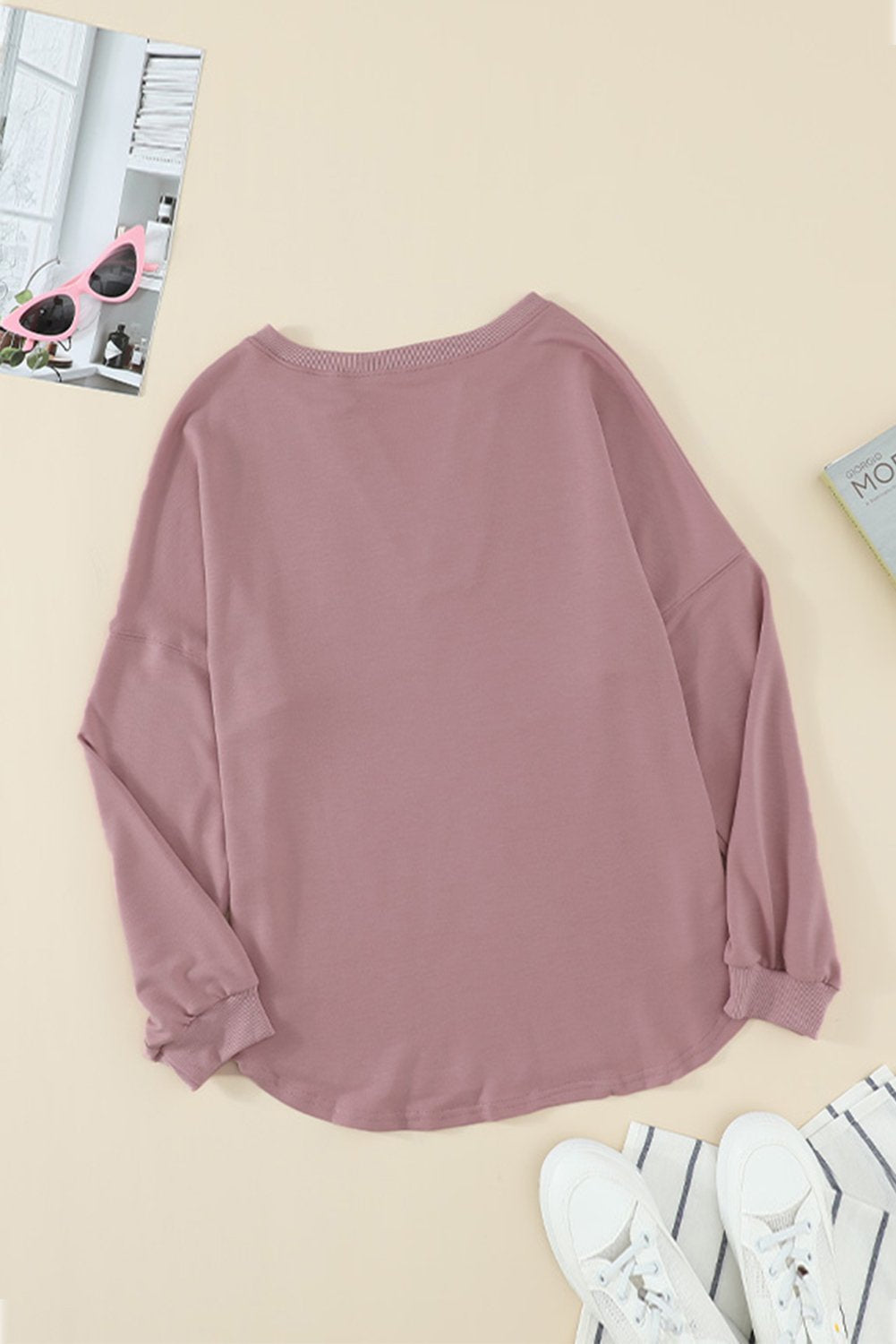 Women wearing a pink buttoned V neck cotton loose fit top, showcasing its stylish design and casual fit.