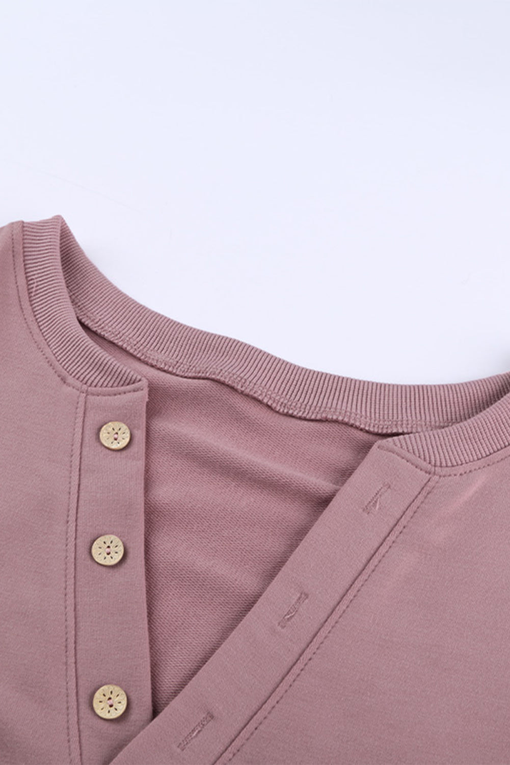 Women wearing a pink buttoned V neck cotton loose fit top, showcasing its stylish design and casual fit.