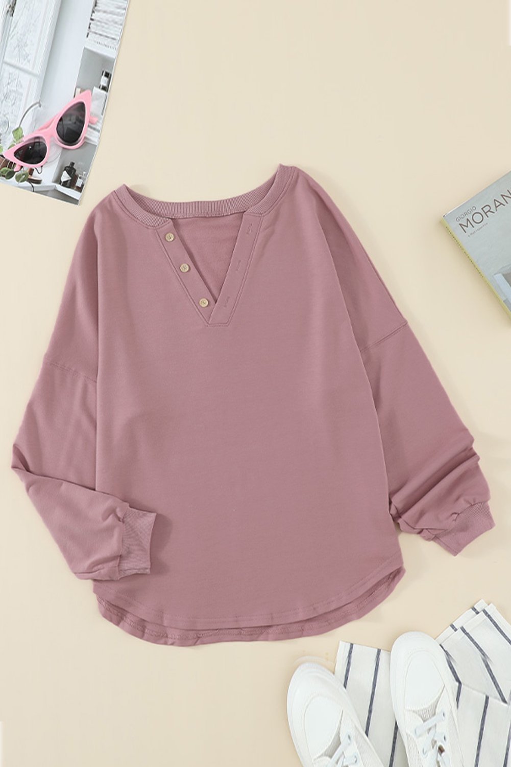 Women wearing a pink buttoned V neck cotton loose fit top, showcasing its stylish design and casual fit.