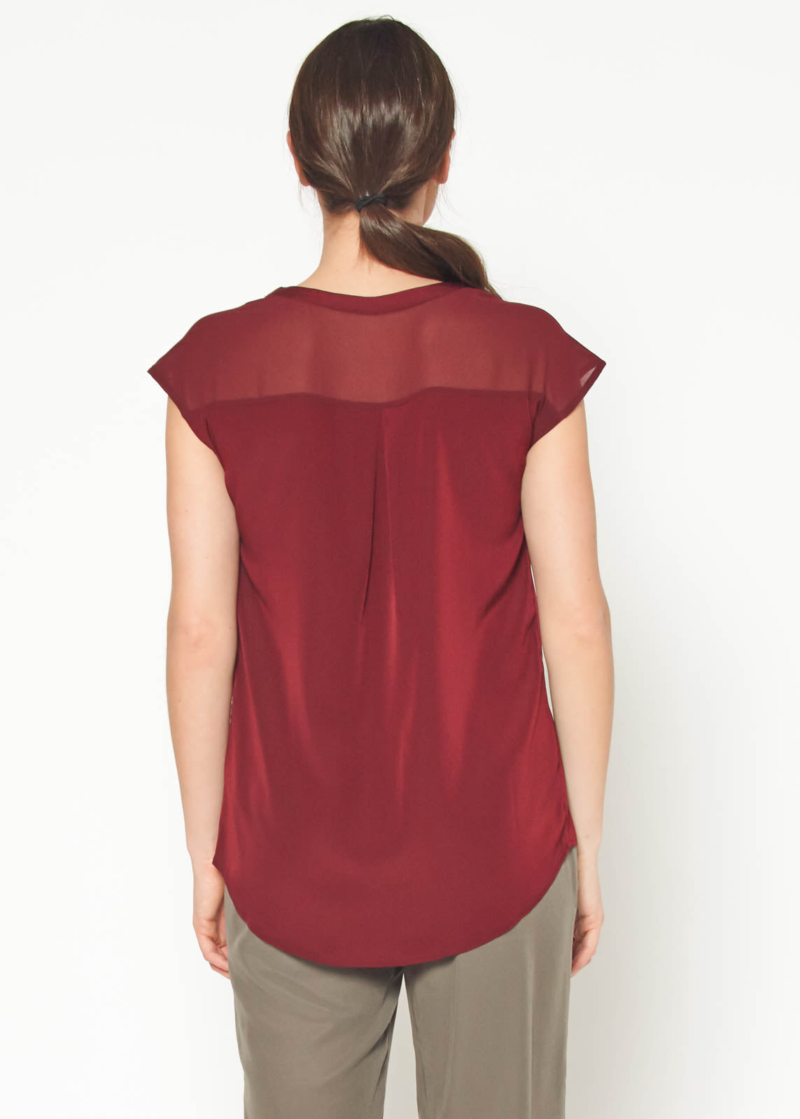 Women's burgundy sleeveless V neck button top displayed on a mannequin, showcasing its elegant design and fabric texture.