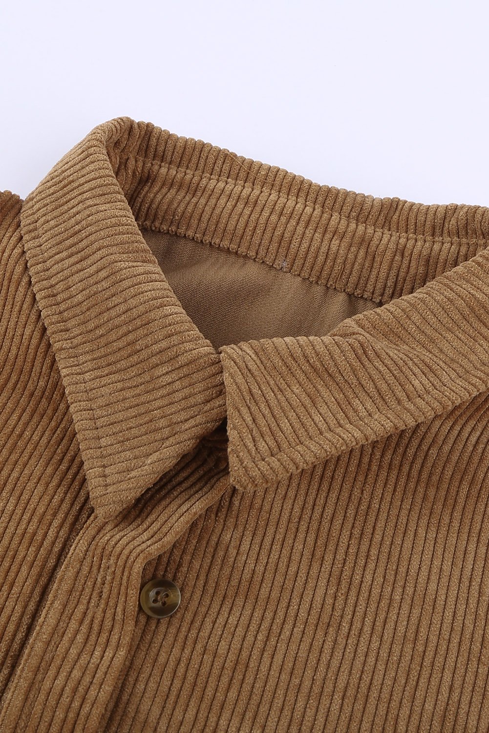 A stylish women's brown corduroy button pocket shirt with full sleeves and a turn-down collar, featuring button cuffs and two front pockets.