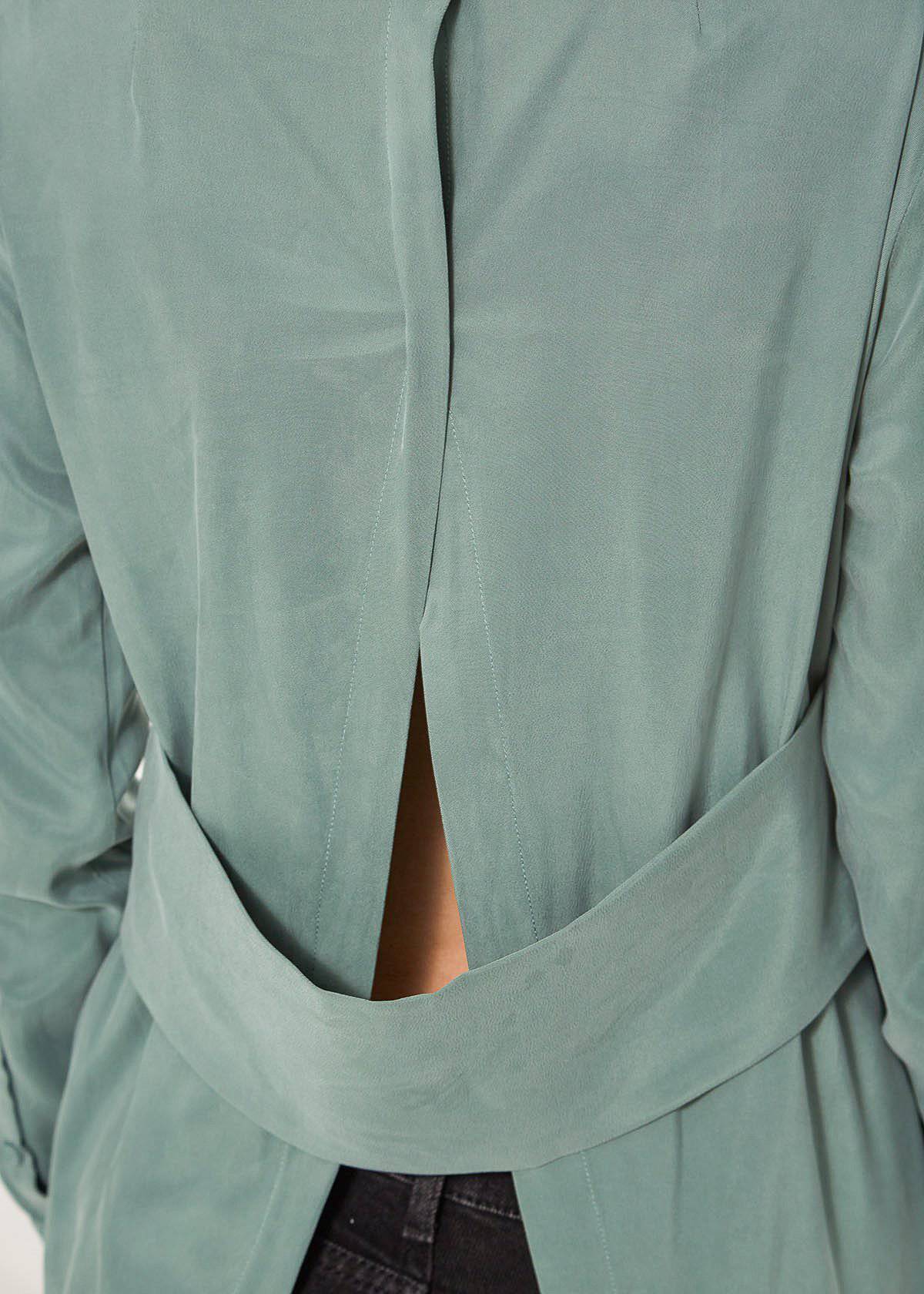 Women's Button Up Open Back Blouse in Sage featuring a chic open back design, front button closure, and two chest pockets.