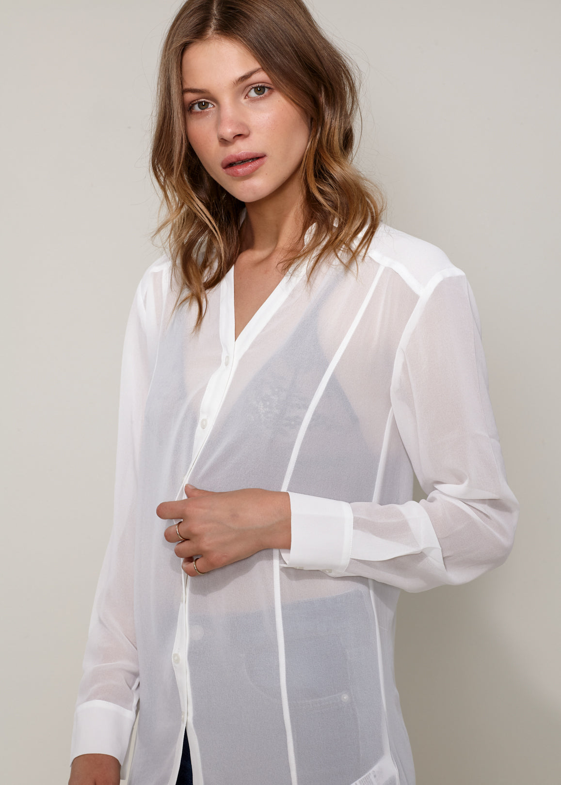 Women's Casual Sheer Hi-Lo Blouse featuring O-ring accent and hi-lo hem design, made from 100% polyester.