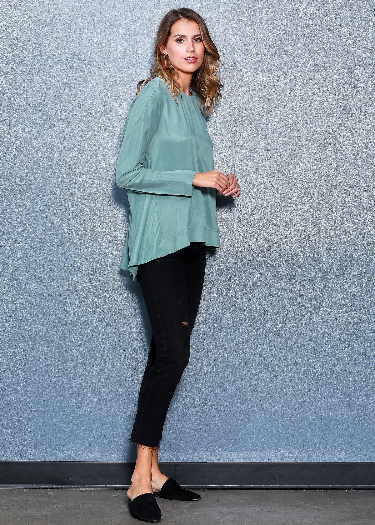 Women's Crewneck Hi-lo Top in Sage featuring a flared hem and hidden shoulder zipper, showcasing a stylish and comfortable design.