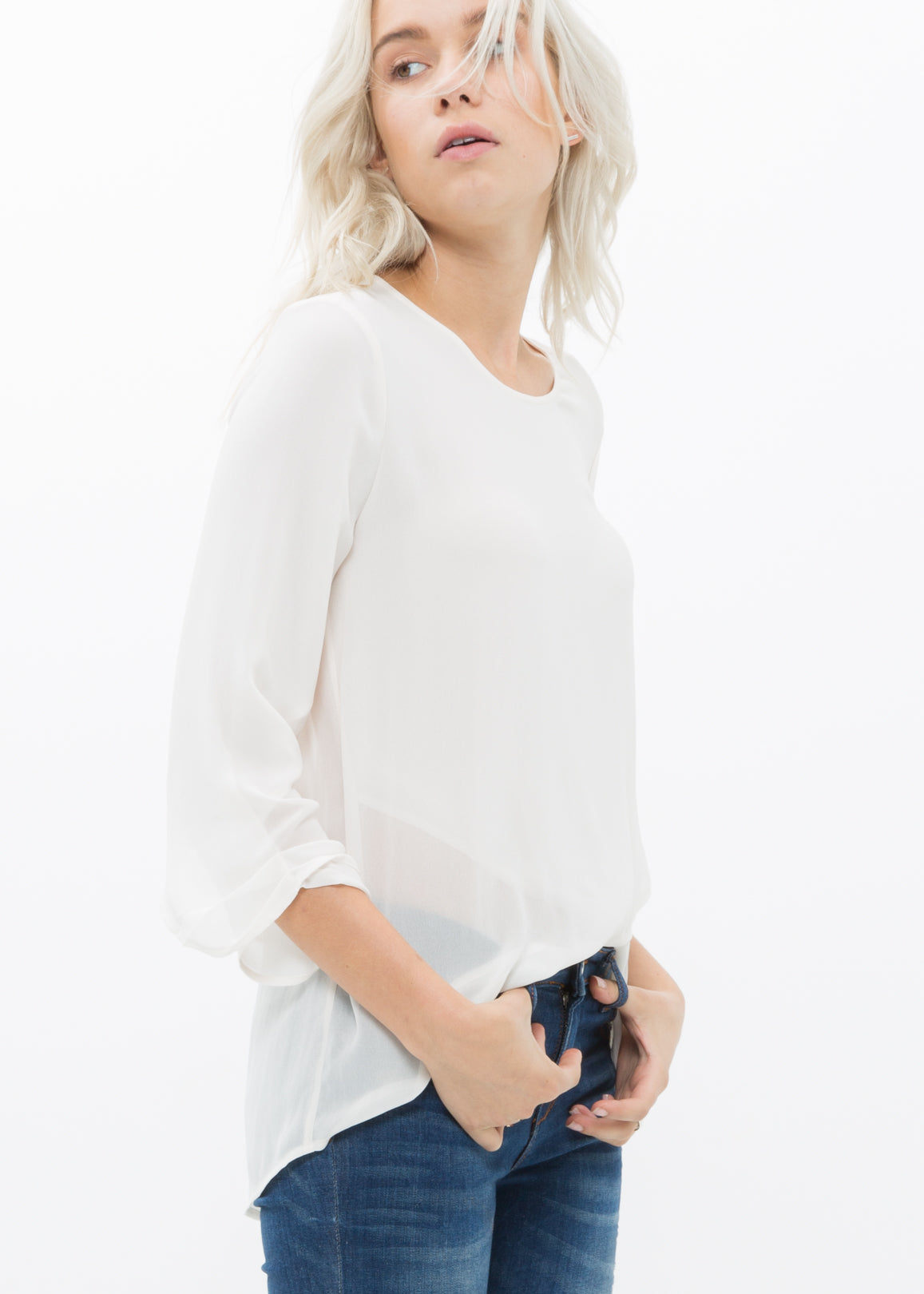 Women's Cross Hem Blouse featuring a surplice hem and gathered cuff details, made from lightweight polyester.