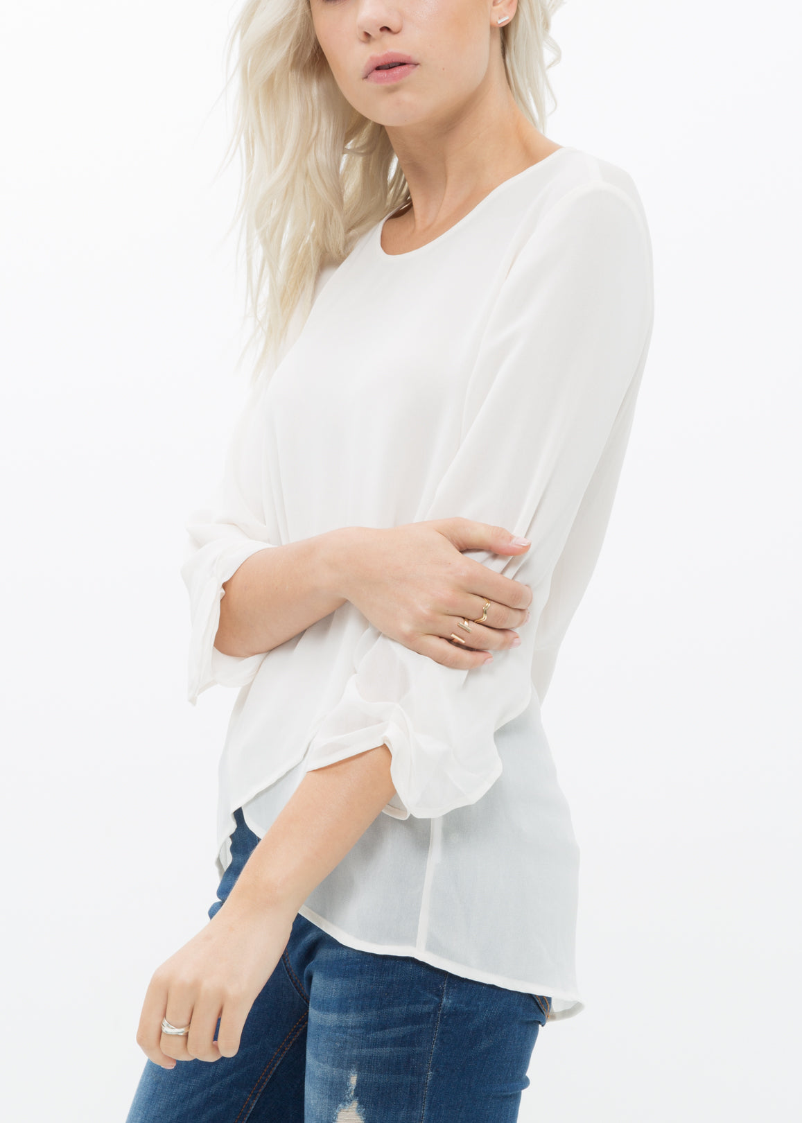 Women's Cross Hem Blouse featuring a surplice hem and gathered cuff details, made from lightweight polyester.