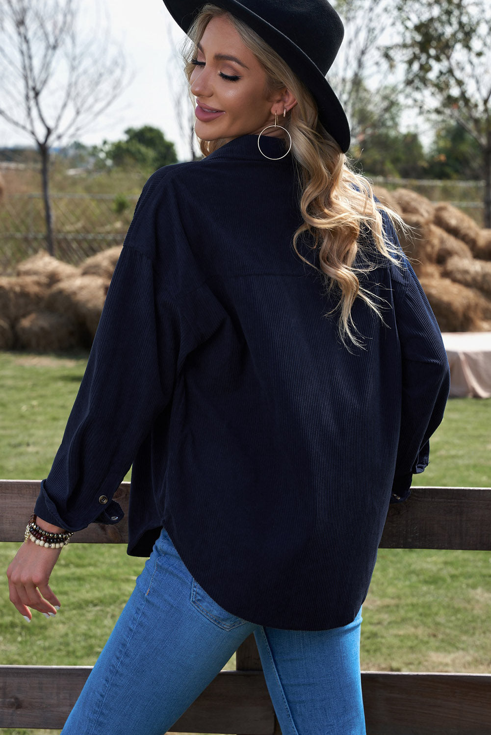 Women's dark blue corduroy shirt with button closure and pockets, featuring a turn-down collar and full sleeves.