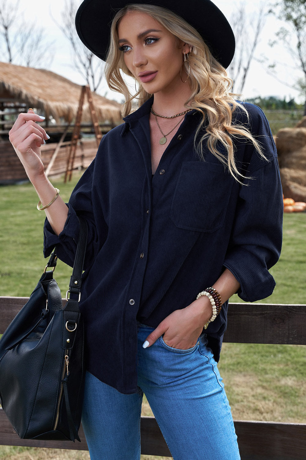 Women's dark blue corduroy shirt with button closure and pockets, featuring a turn-down collar and full sleeves.