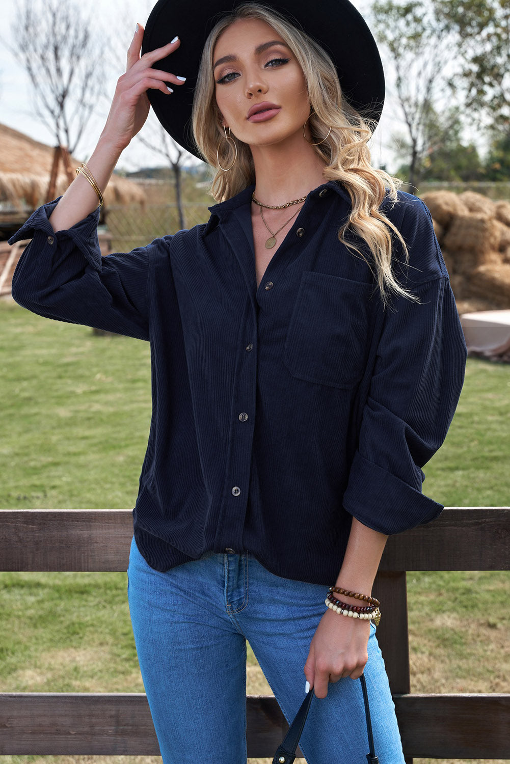 Women's dark blue corduroy shirt with button closure and pockets, featuring a turn-down collar and full sleeves.