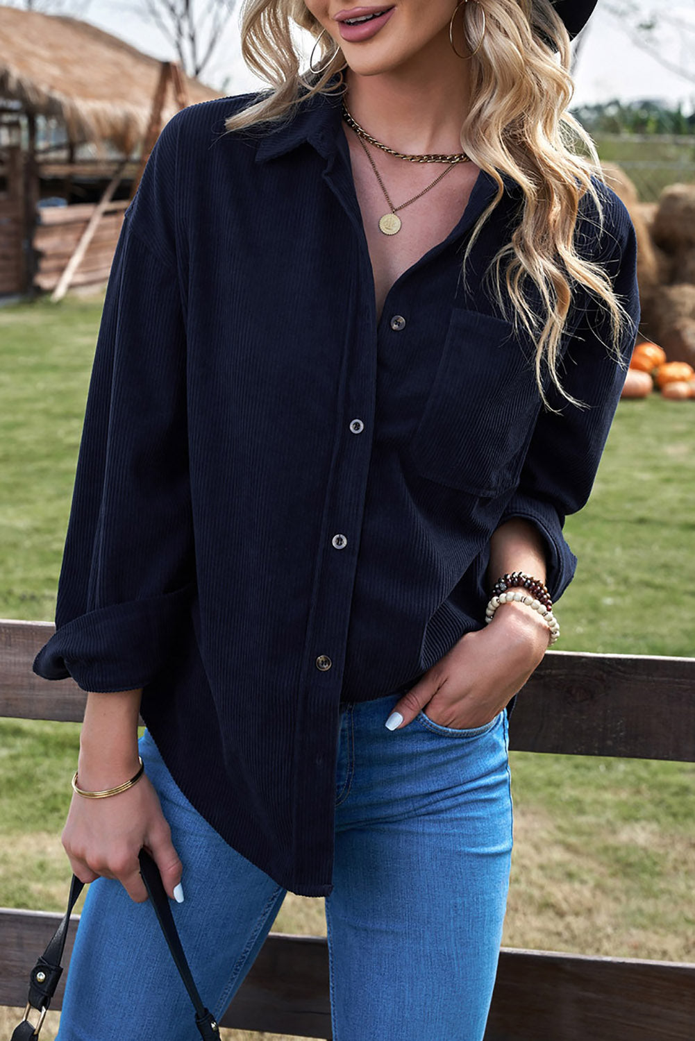 Women's dark blue corduroy shirt with button closure and pockets, featuring a turn-down collar and full sleeves.