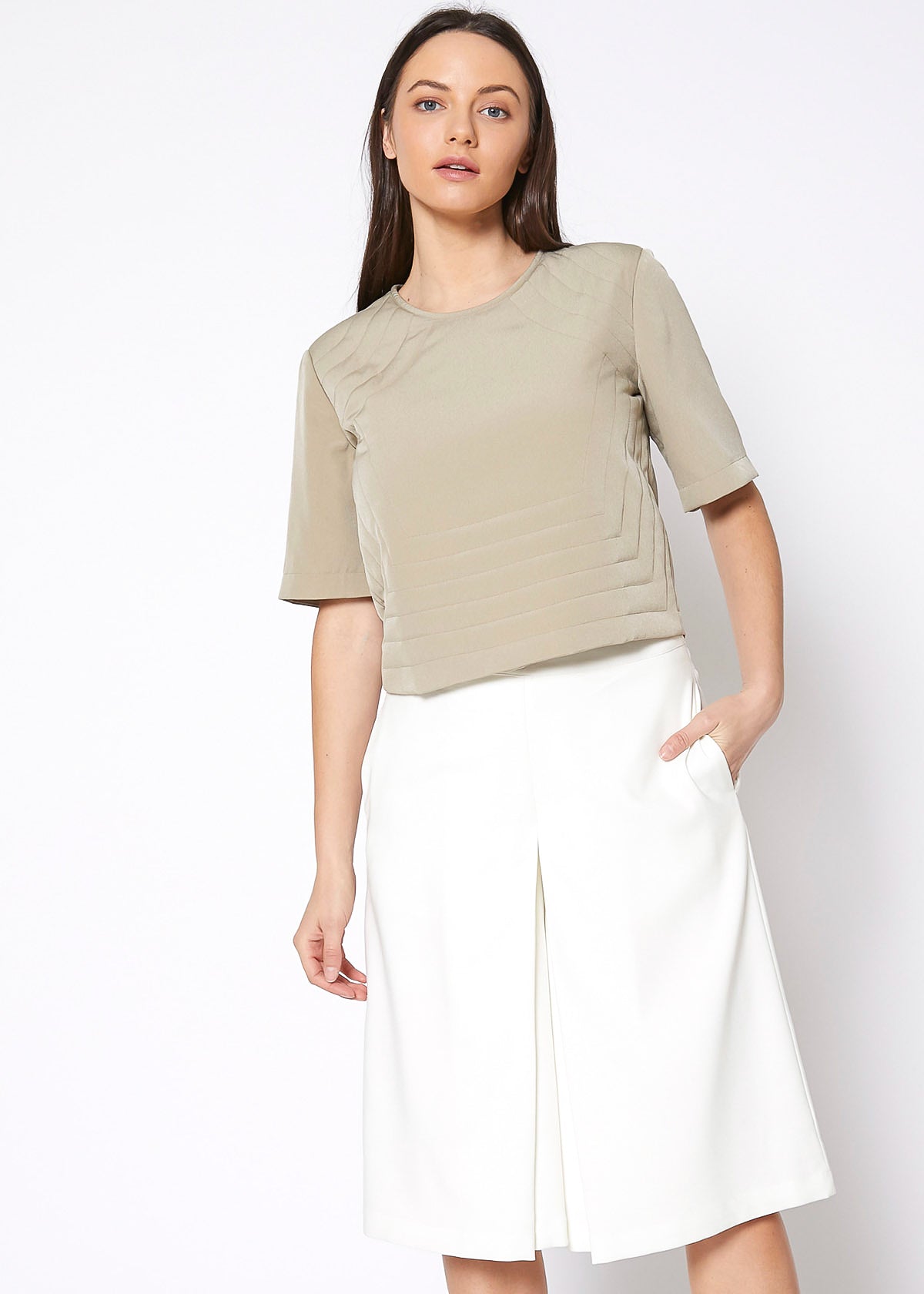 A stylish women's embossed short sleeve crop top in a minimal design, showcasing its unique texture and comfortable fit.