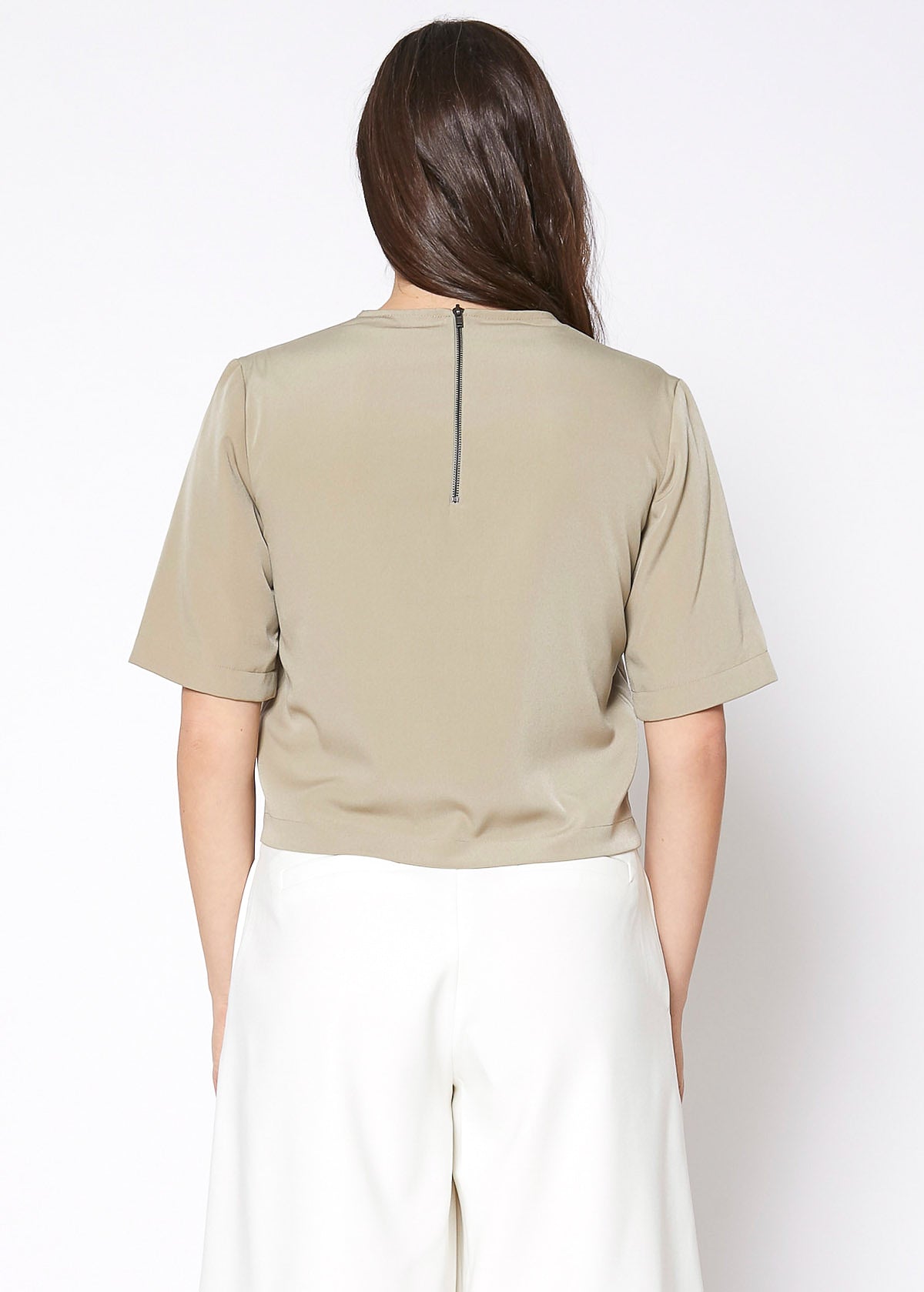 A stylish women's embossed short sleeve crop top in a minimal design, showcasing its unique texture and comfortable fit.