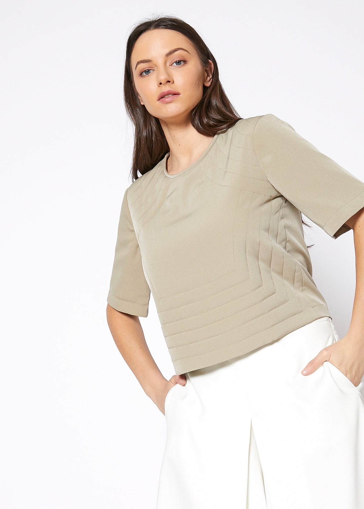 A stylish women's embossed short sleeve crop top in a minimal design, showcasing its unique texture and comfortable fit.