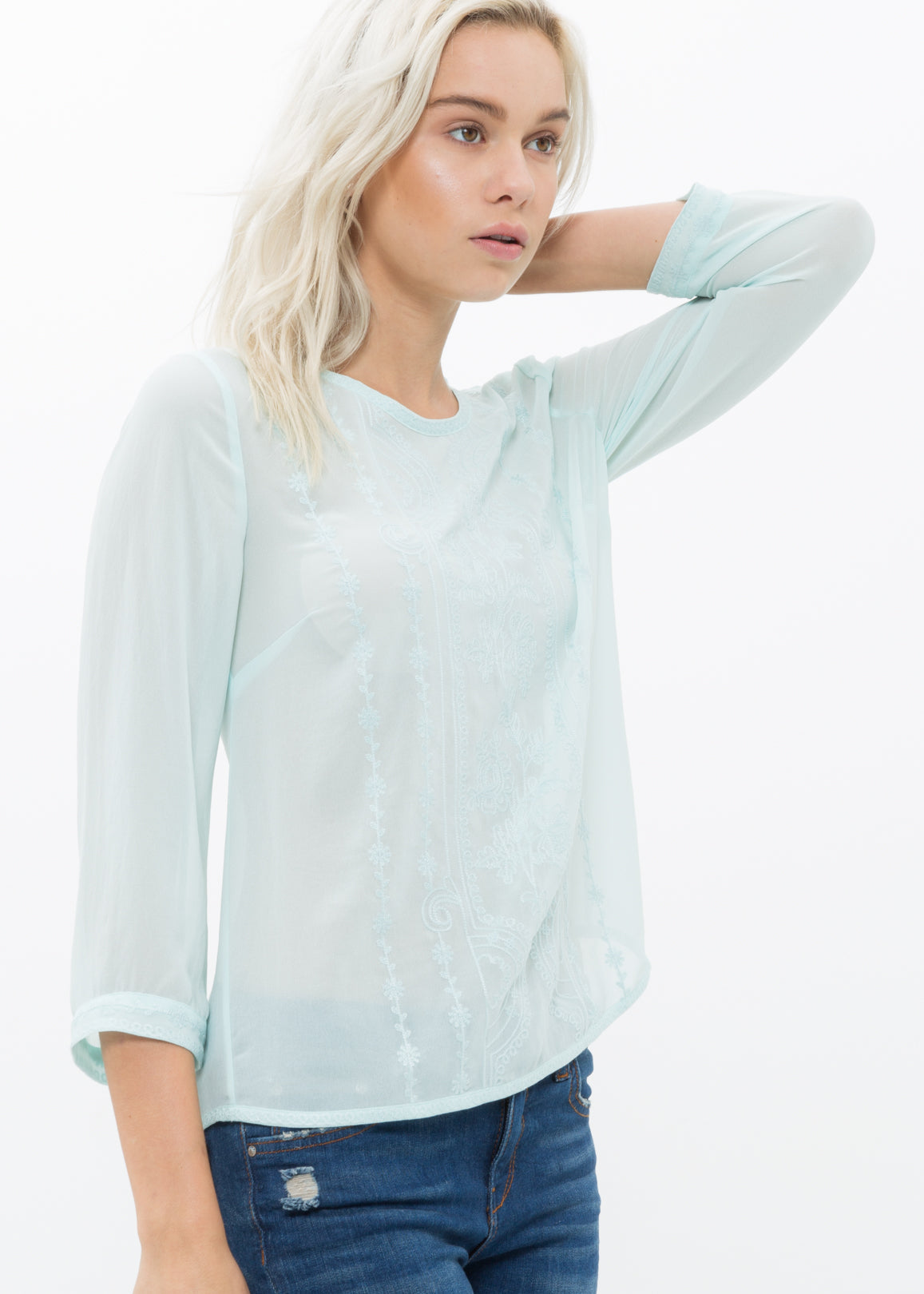 Women's embossed top in pepper mint with front embossing detail and button-back closure, made from 100% polyester.