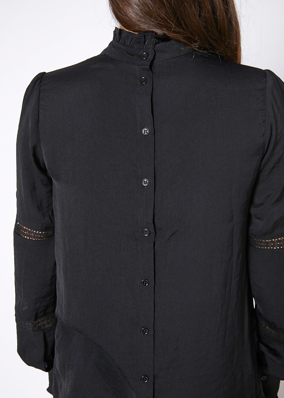 Women's Eyelet Long Sleeve Mock Neck Top featuring intricate eyelet details and a stylish back button closure.