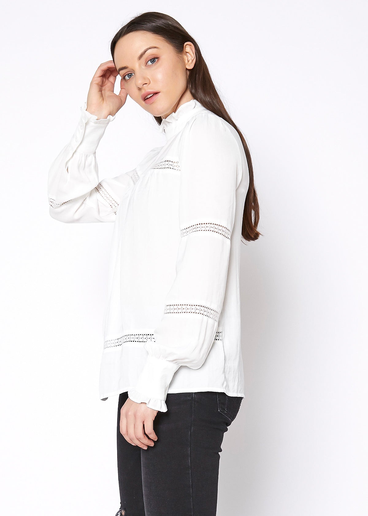 Women's Eyelet Long Sleeve Mock Neck Top featuring intricate eyelet details and a stylish back button closure.