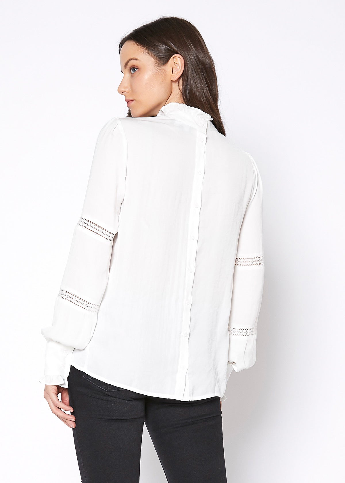 Women's Eyelet Long Sleeve Mock Neck Top featuring intricate eyelet details and a stylish back button closure.