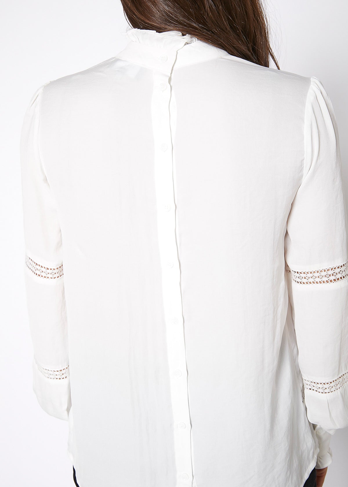 Women's Eyelet Long Sleeve Mock Neck Top featuring intricate eyelet details and a stylish back button closure.