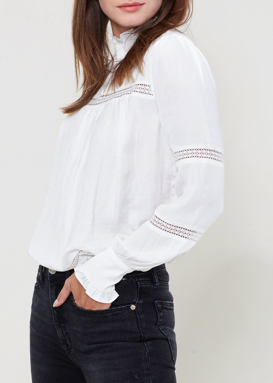 Women's Eyelet Long Sleeve Mock Neck Top featuring intricate eyelet details and a stylish back button closure.