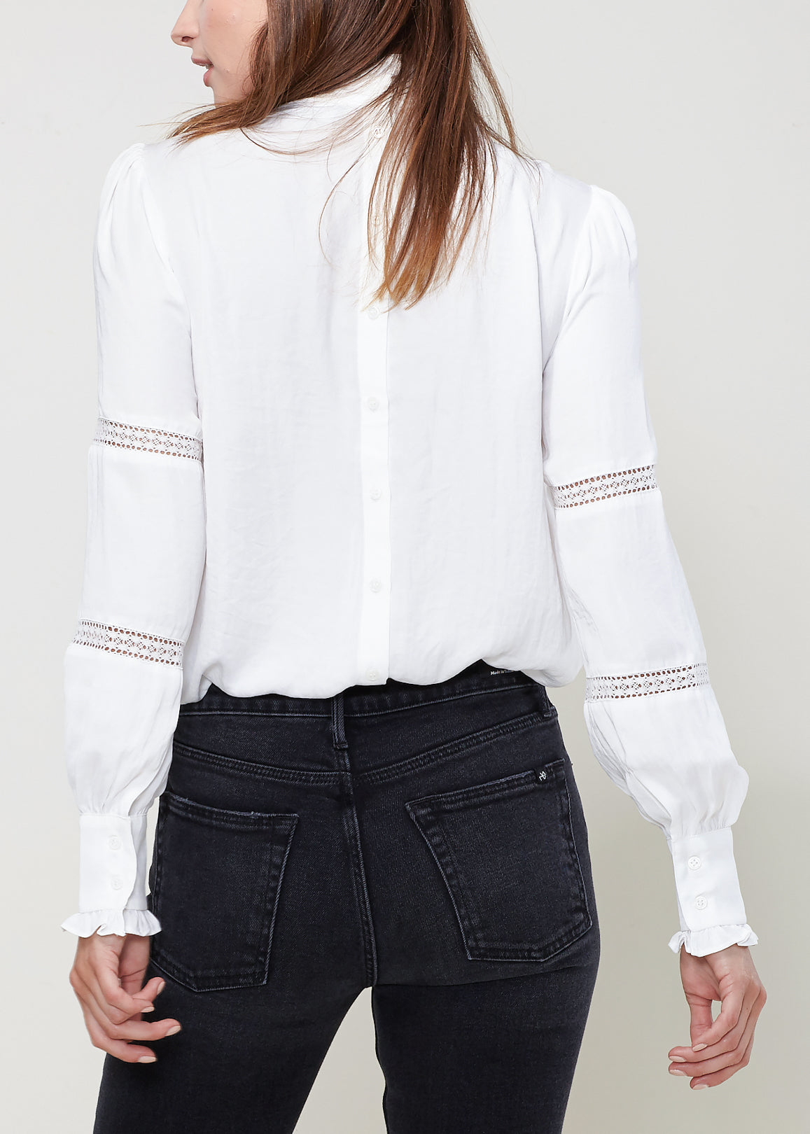 Women's Eyelet Long Sleeve Mock Neck Top featuring intricate eyelet details and a stylish back button closure.