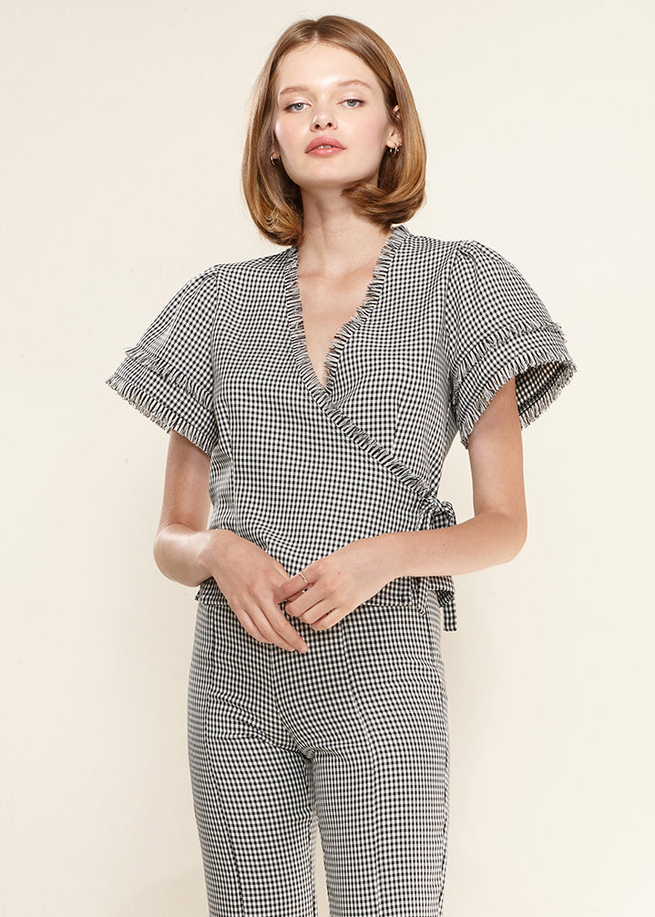 Women's Fringe Trim Gingham Wrap Blouse featuring a stylish side tie and fringe detailing in a classic gingham pattern.