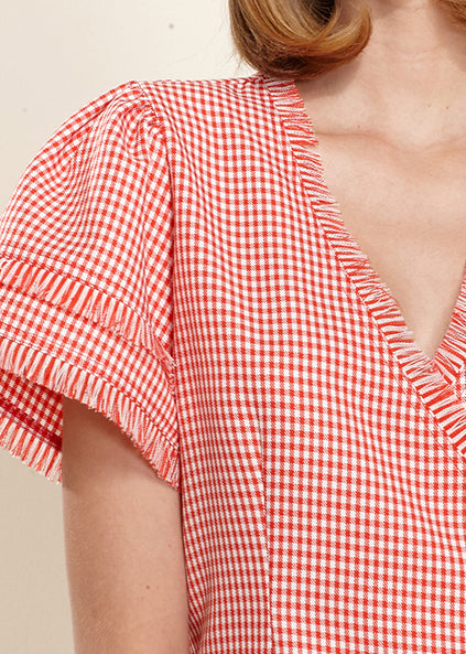 Women's Fringe Trim Gingham Wrap Blouse featuring a stylish side tie and fringe detailing in a classic gingham pattern.