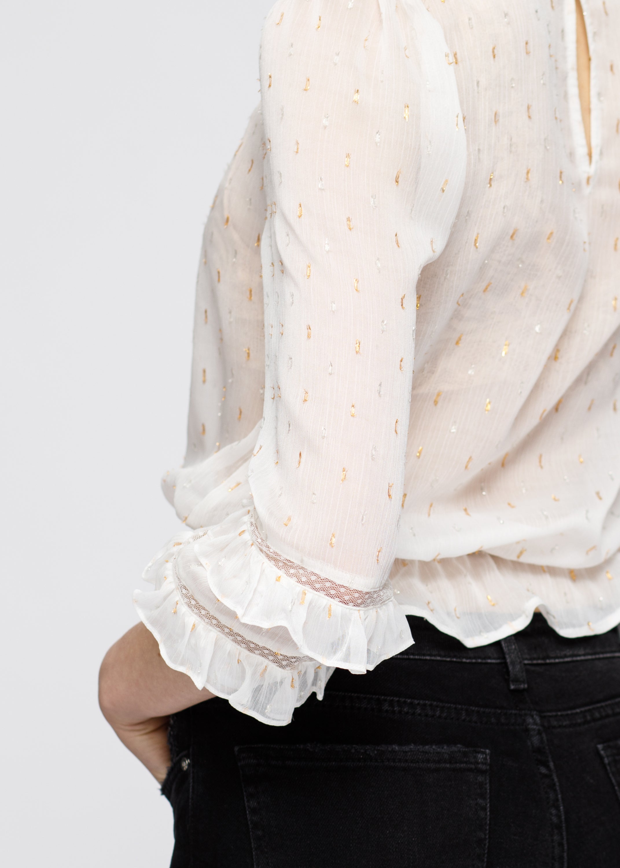 Women's white blouse featuring delicate lace inset and ruffle details, perfect for stylish occasions.