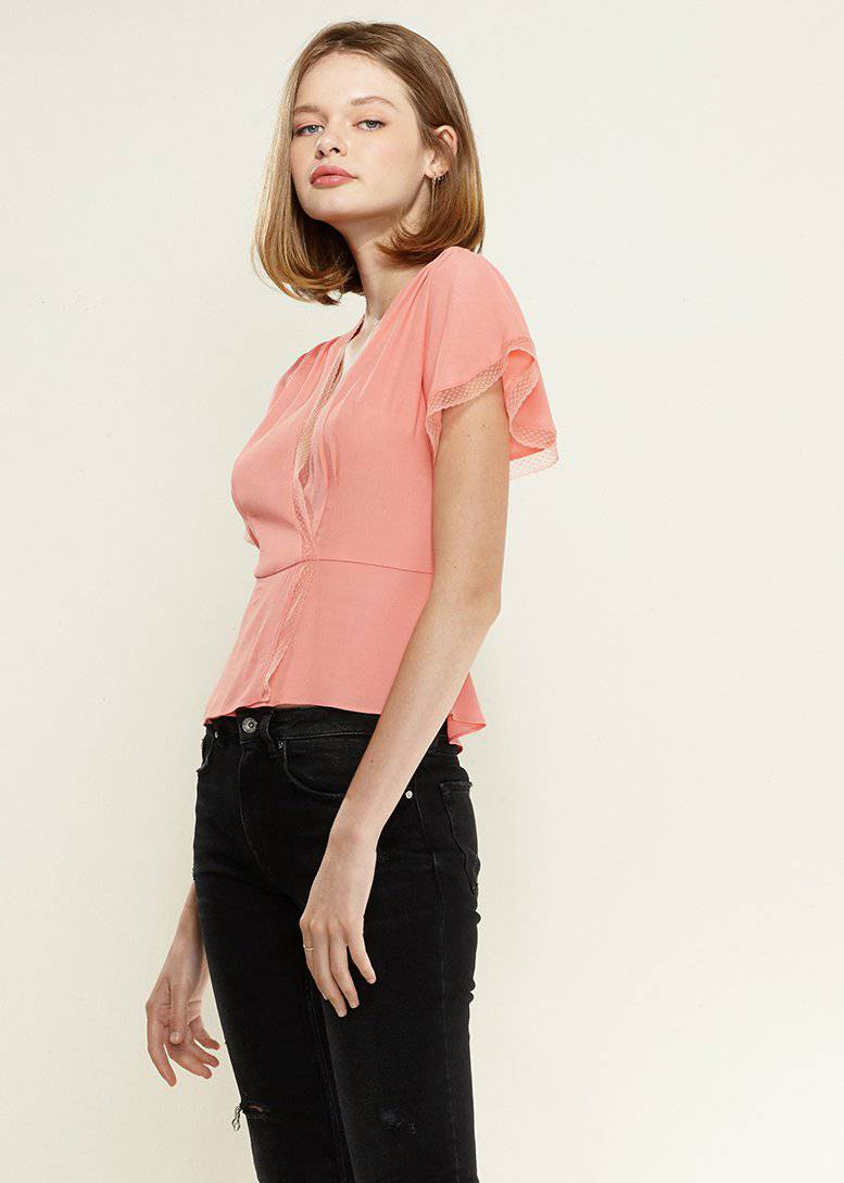 Women's coral blouse with lace trim, flutter sleeves, and deep V-neck, featuring a waist tie for a flattering fit.