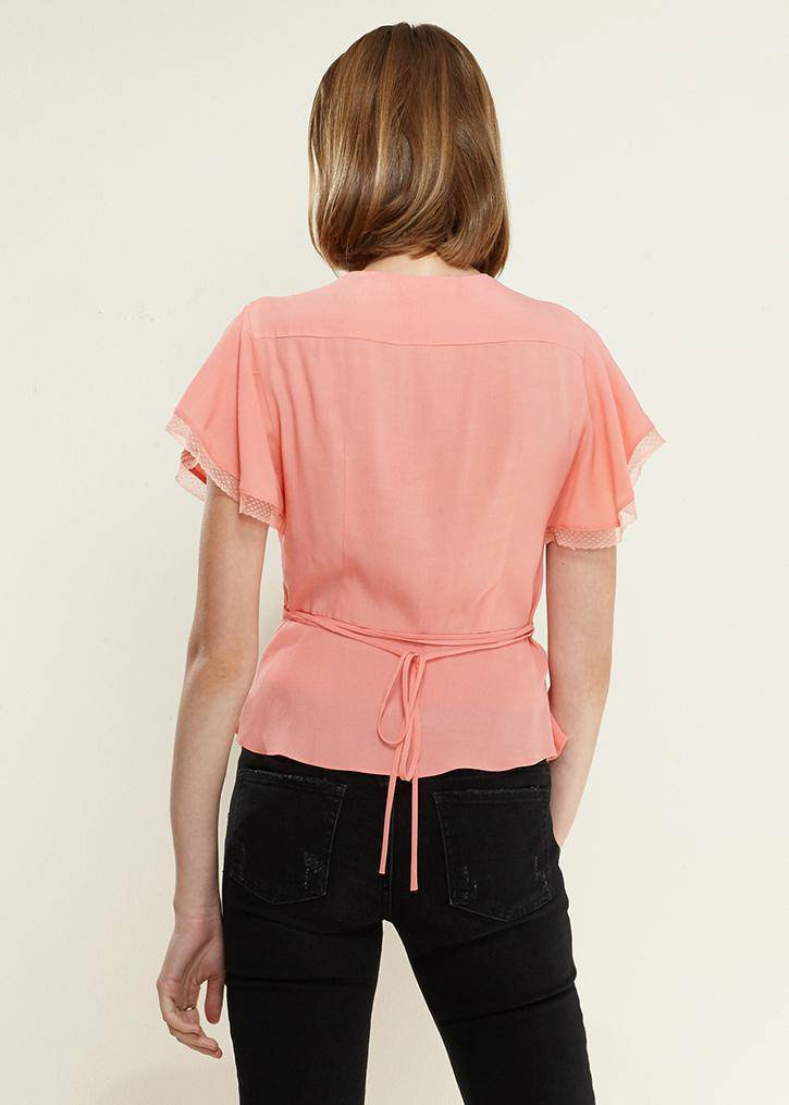 Women's coral blouse with lace trim, flutter sleeves, and deep V-neck, featuring a waist tie for a flattering fit.