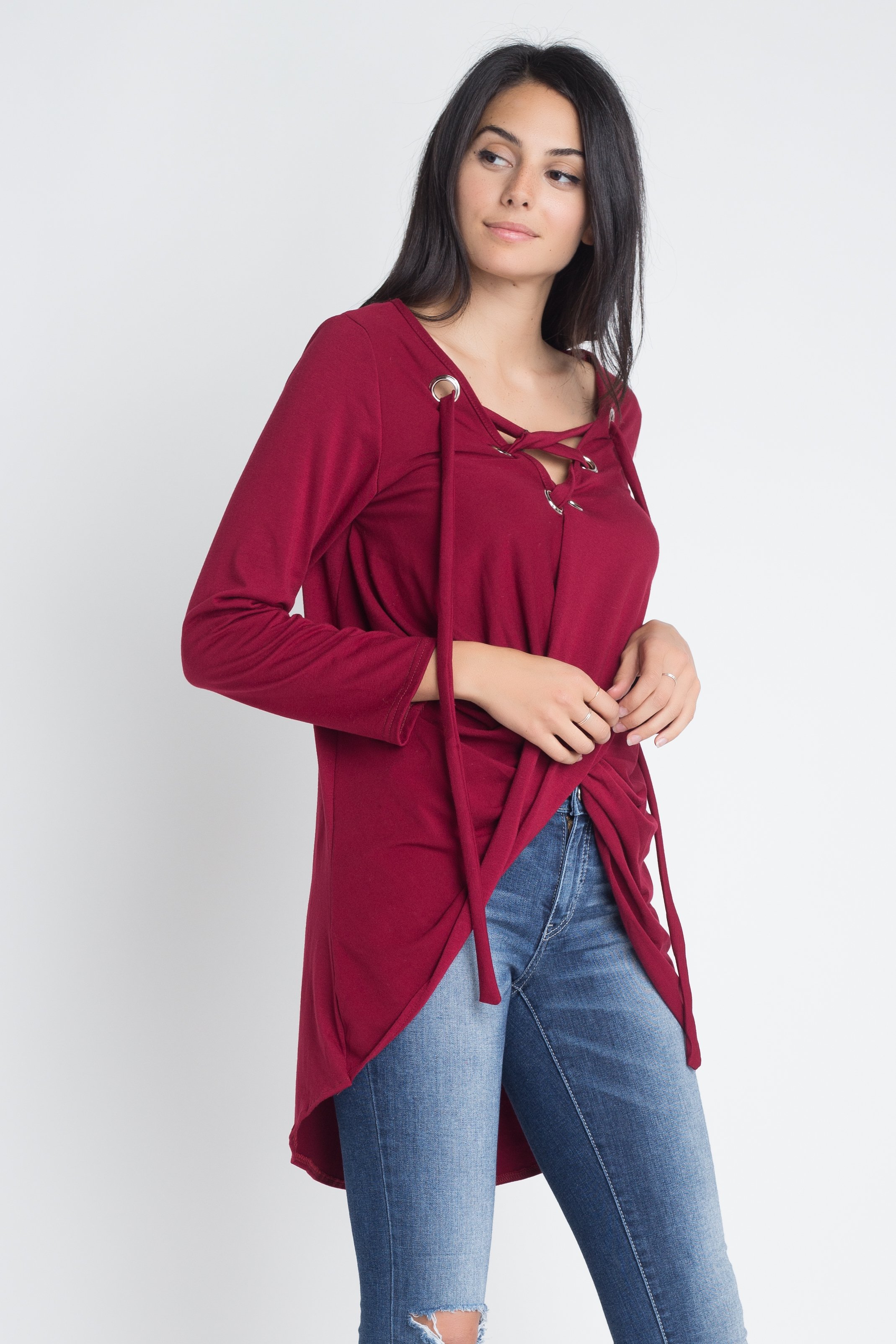 Women's long sleeve top with lace-up neckline and wrap front design, showcasing a stylish and elegant look.