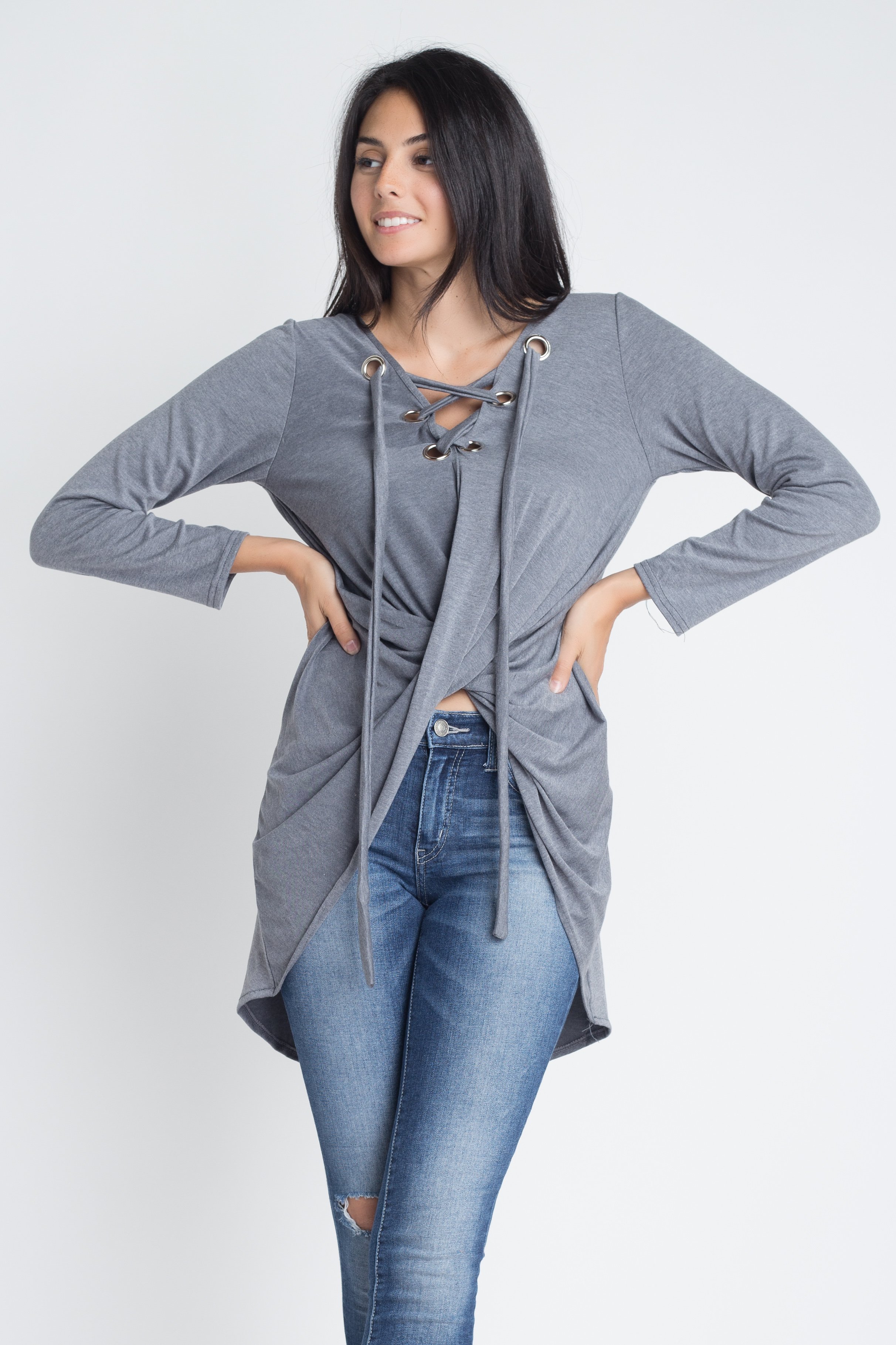 Women's long sleeve top with lace-up neckline and wrap front design, showcasing a stylish and elegant look.