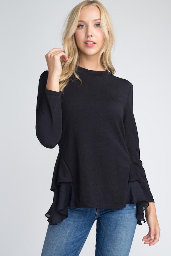 Women's Long Sleeve Ruffle Top featuring ruffles at the bottom, model wearing size Small/Medium.