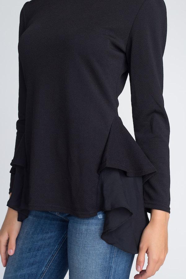 Women's Long Sleeve Ruffle Top featuring ruffles at the bottom, model wearing size Small/Medium.