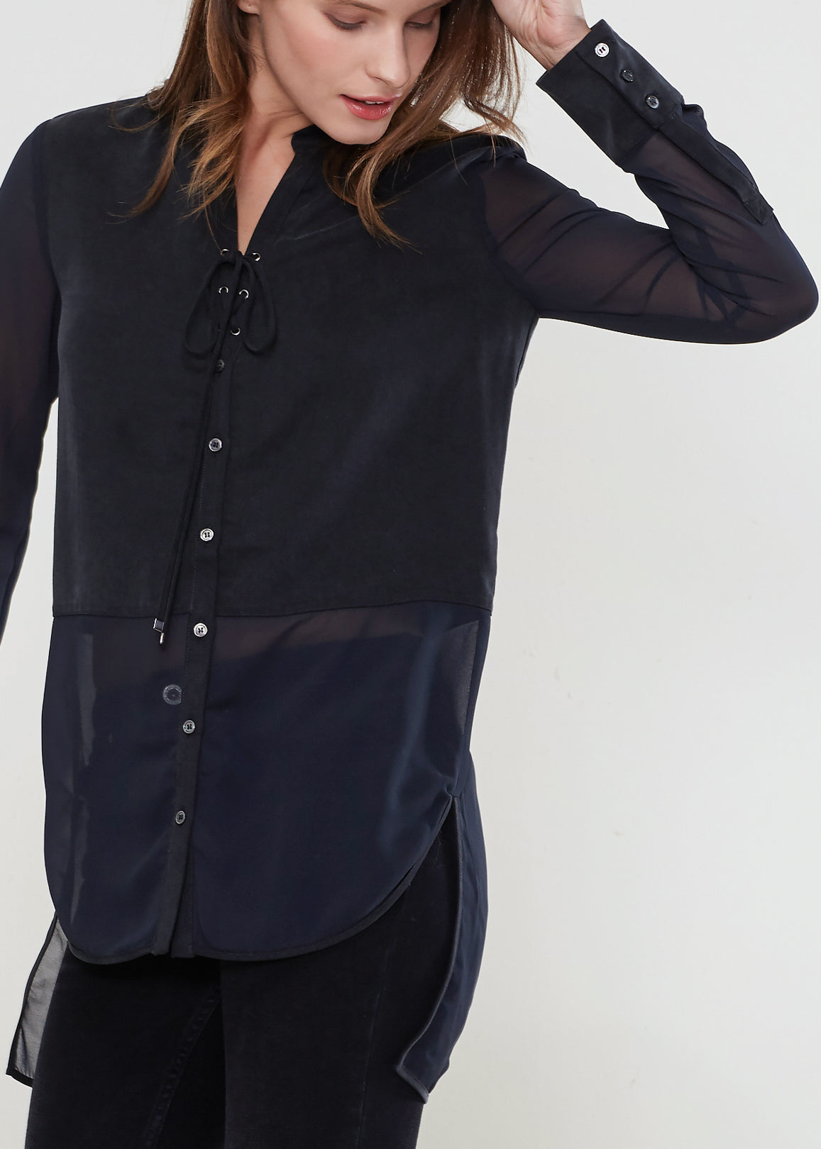 Women's black button-up shirt with sheer mesh sleeves and hem, showcasing a stylish and casual design.