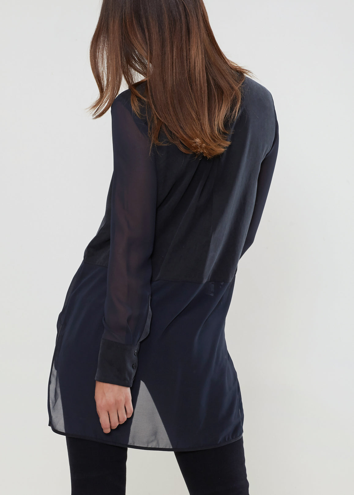 Women's black button-up shirt with sheer mesh sleeves and hem, showcasing a stylish and casual design.