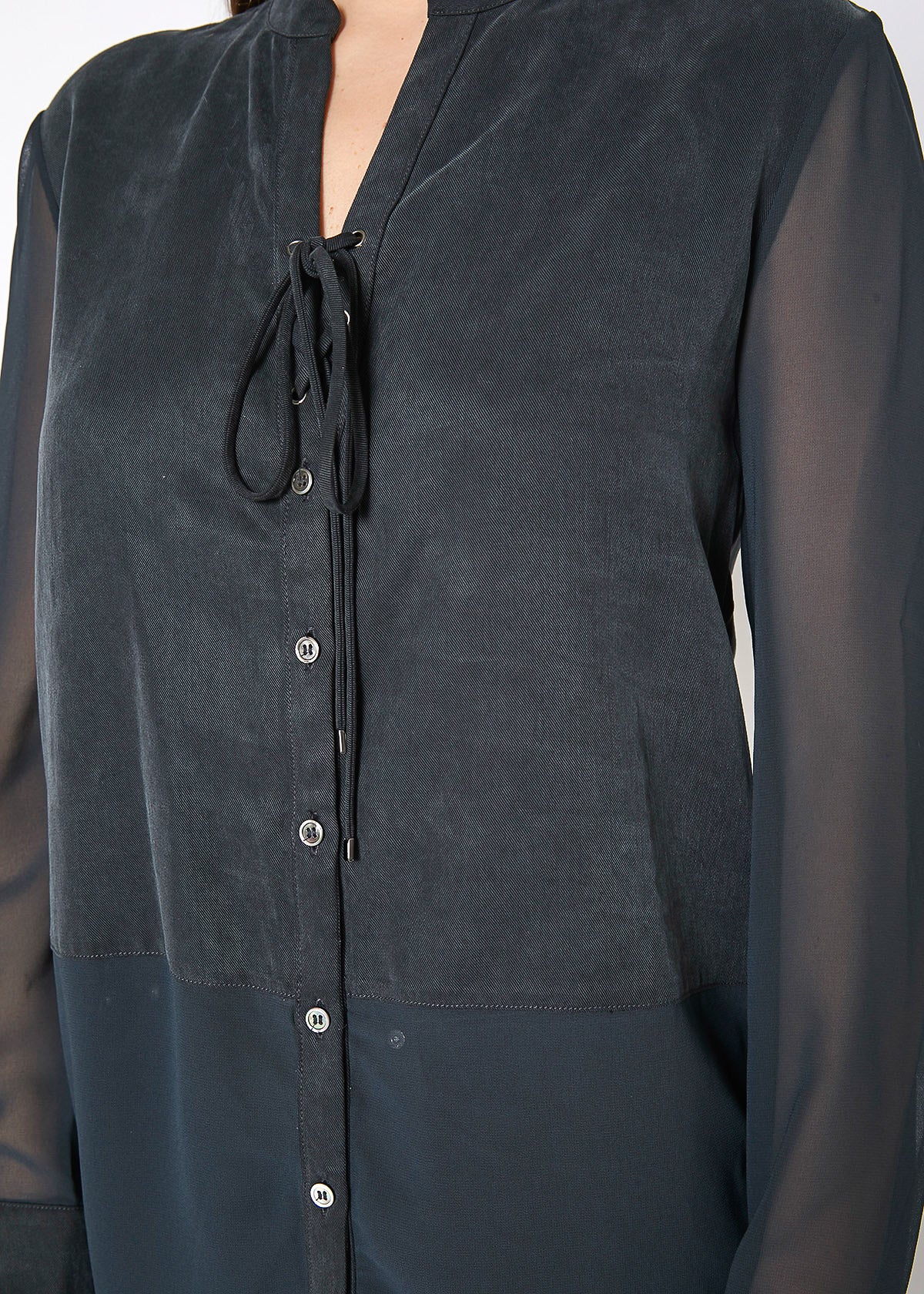 Women's black button-up shirt with sheer mesh sleeves and hem, showcasing a stylish and casual design.